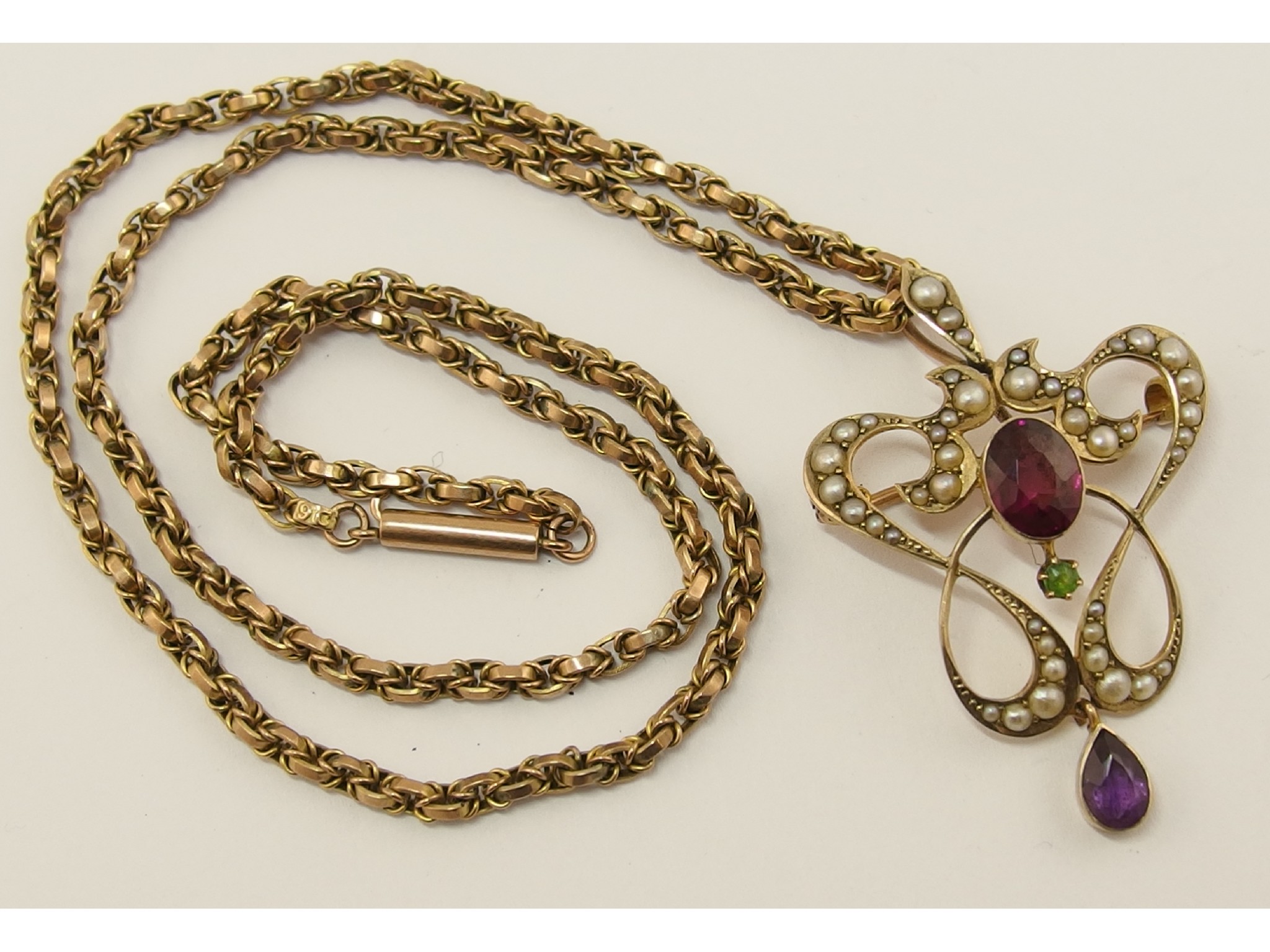 Appraisal: An Edwardian pendant brooch set with seed pearls amethyst garnet