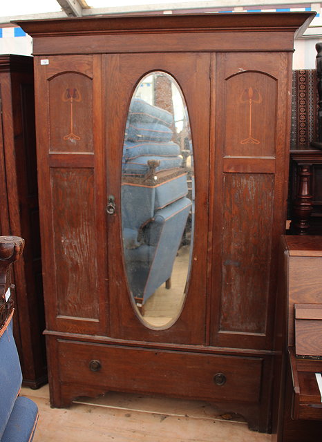 Appraisal: A WARDROBE with single mirrored door flanked by panels to