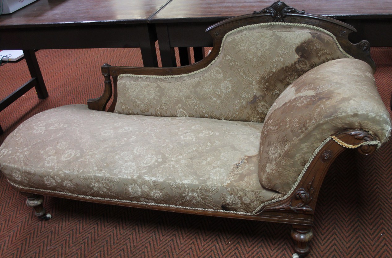 Appraisal: A late Victorian walnut framed chaise longue the shaped back