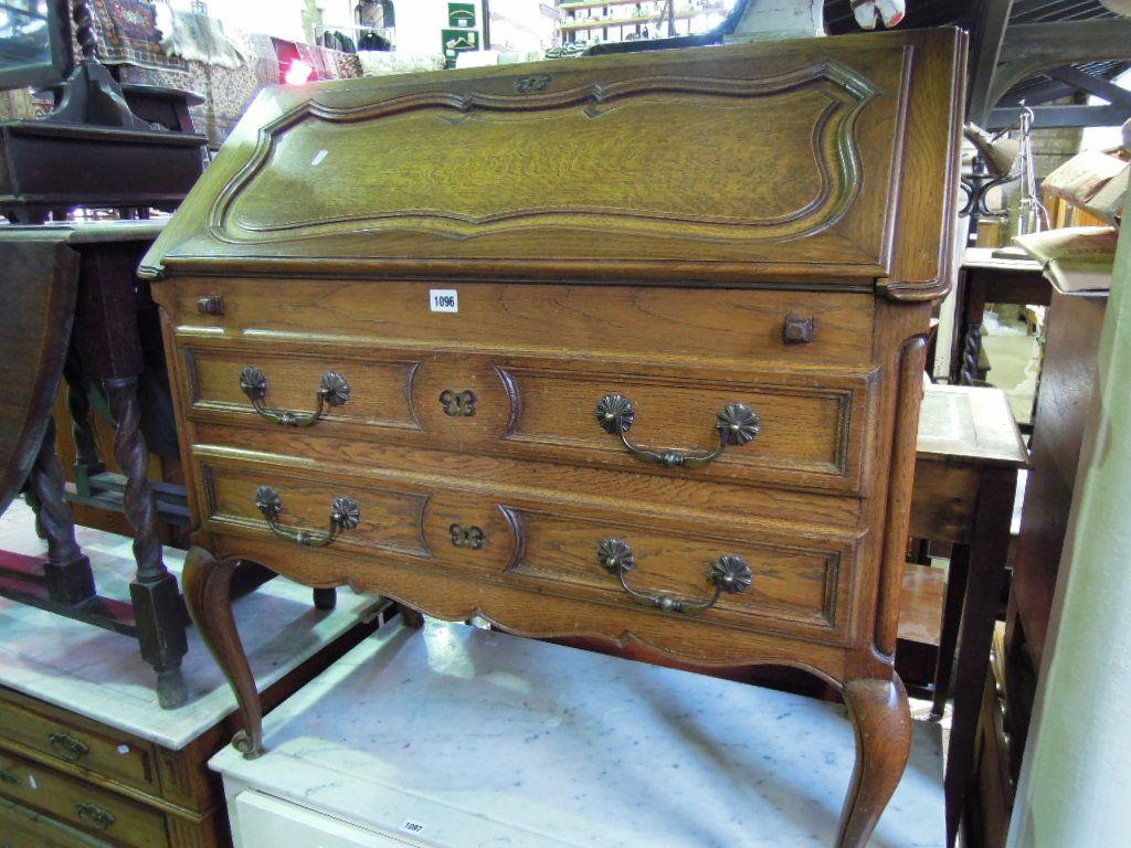 Appraisal: A French oak bureau the shaped and moulded panelled fall