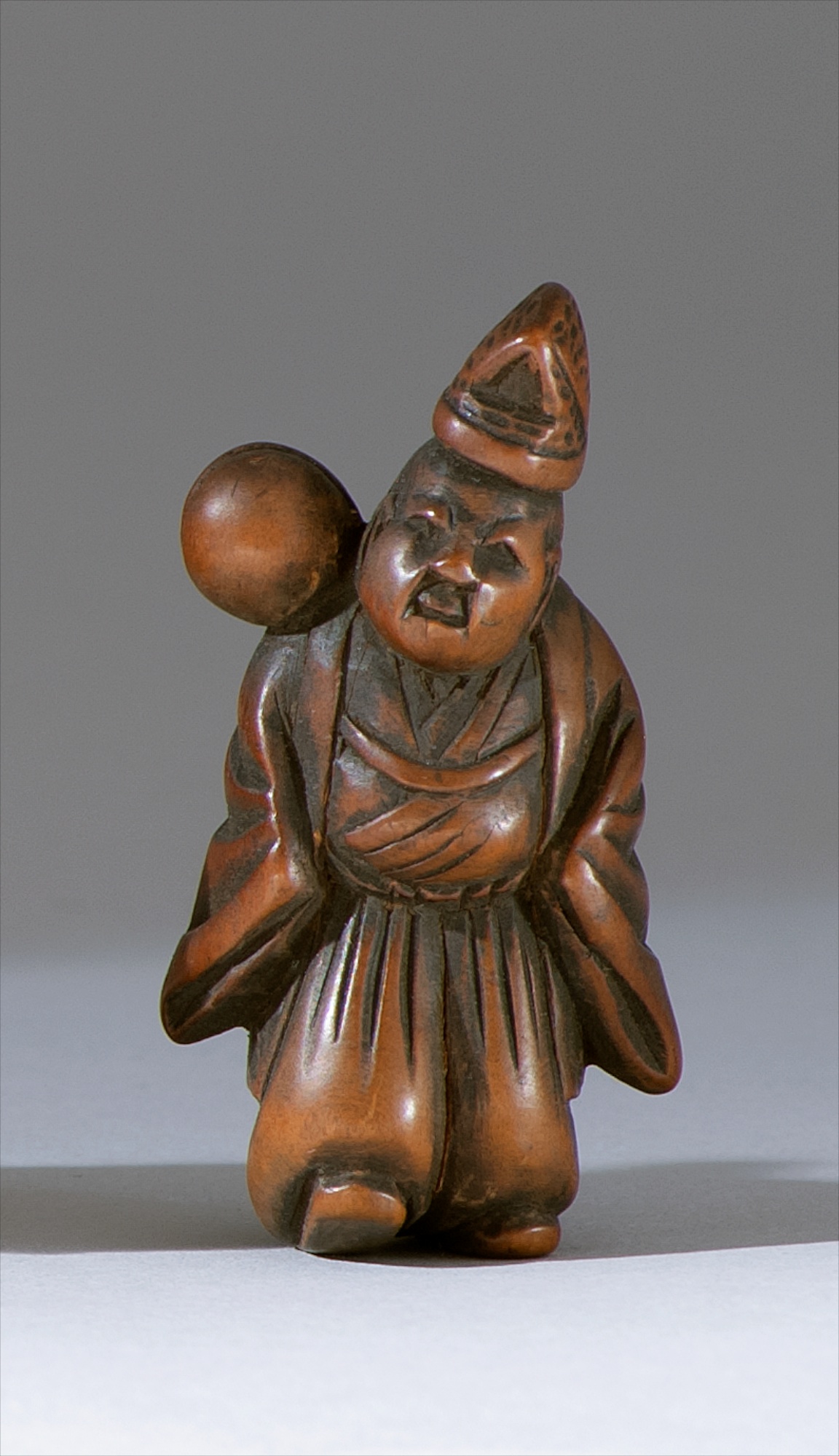 Appraisal: WOOD NETSUKE th CenturyDepicting a priest with a mokugyo bell