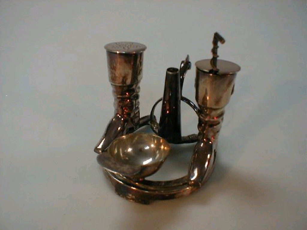 Appraisal: An electroplate cruet set in the form of a horseshoe