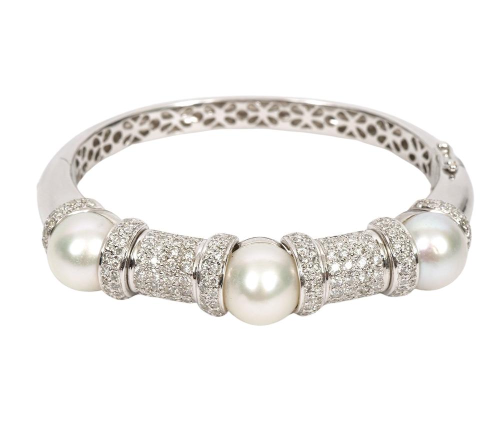 Appraisal: Contemporary diamond and white pearl K white gold hinged bangle