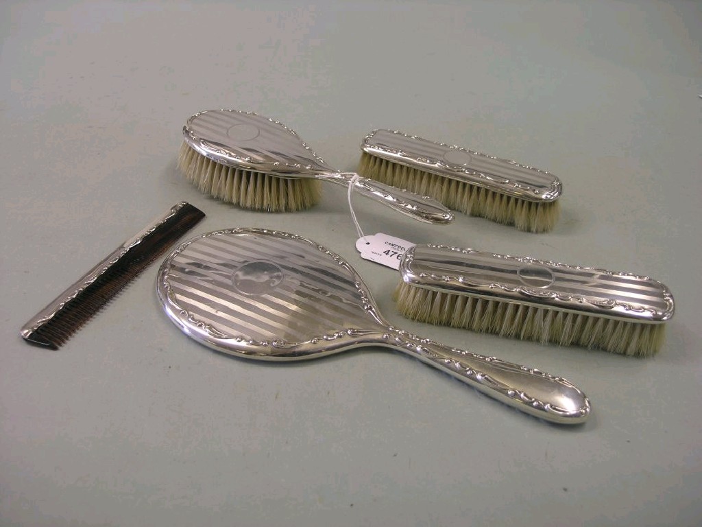 Appraisal: A silver dressing table set hairbrush pair of clothes brushes