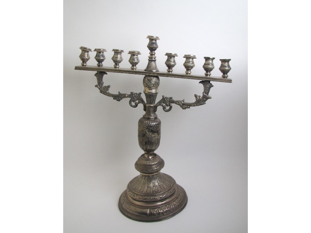 Appraisal: A silver Menorah with nine sconces supported by foliate branches