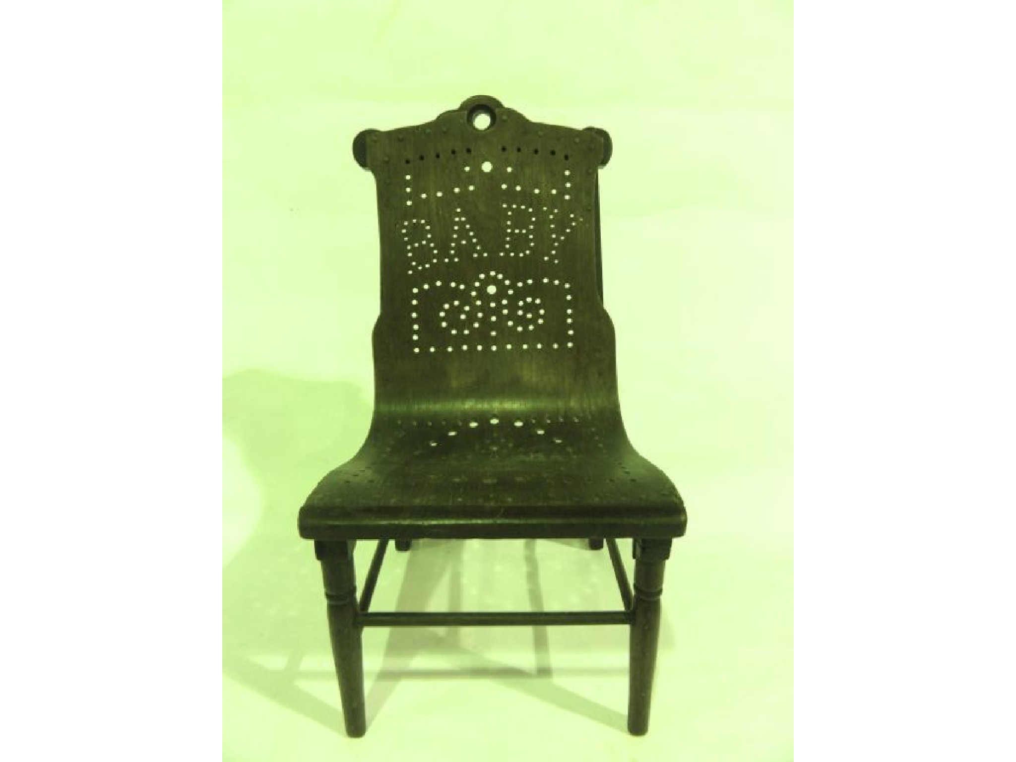 Appraisal: A miniature model chair with turned mahogany framework accommodating a