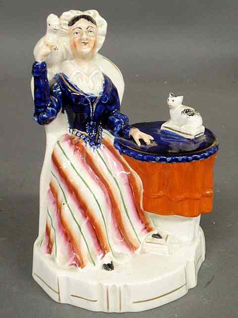 Appraisal: Staffordshire figure of a seated woman with a bird and