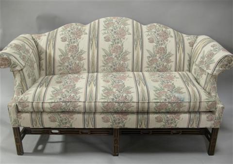 Appraisal: CHIPPENDALE STYLE UPHOLSTERED SETTEE th century the shaped upholstered back