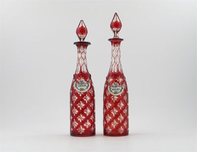 Appraisal: A pair of ruby-flashed glass decanters and stoppers the tall