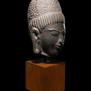 Appraisal: A Khmer Stone Head of Deity bearing a subtle smile