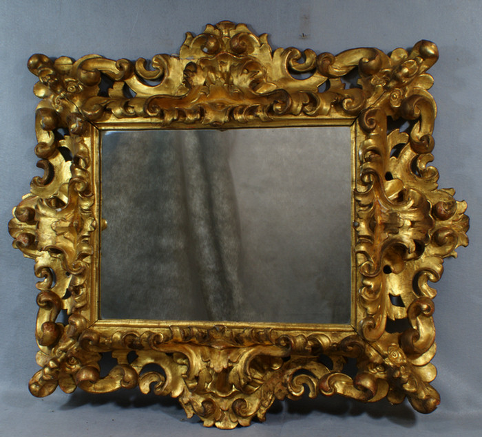 Appraisal: Carved gilt wood mirror with stylized mask corners latae th