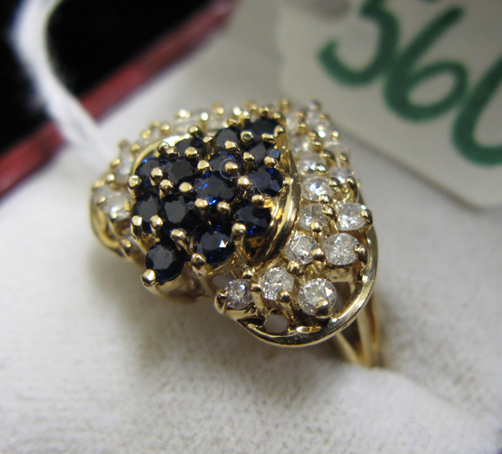 Appraisal: SAPPHIRE DIAMOND AND FOURTEEN KARAT GOLD RING set with a