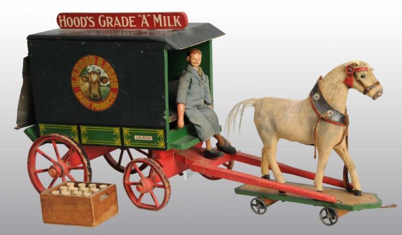 Appraisal: Wooden Hood's Horse-Drawn Milk Wagon Toy Description Wagon is pulled