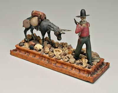 Appraisal: Carved prospector mule walking through rocky area mule staring at