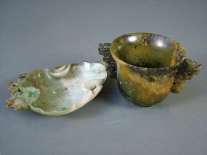 Appraisal: A Chinese variegated green jade twin handled cup the handles