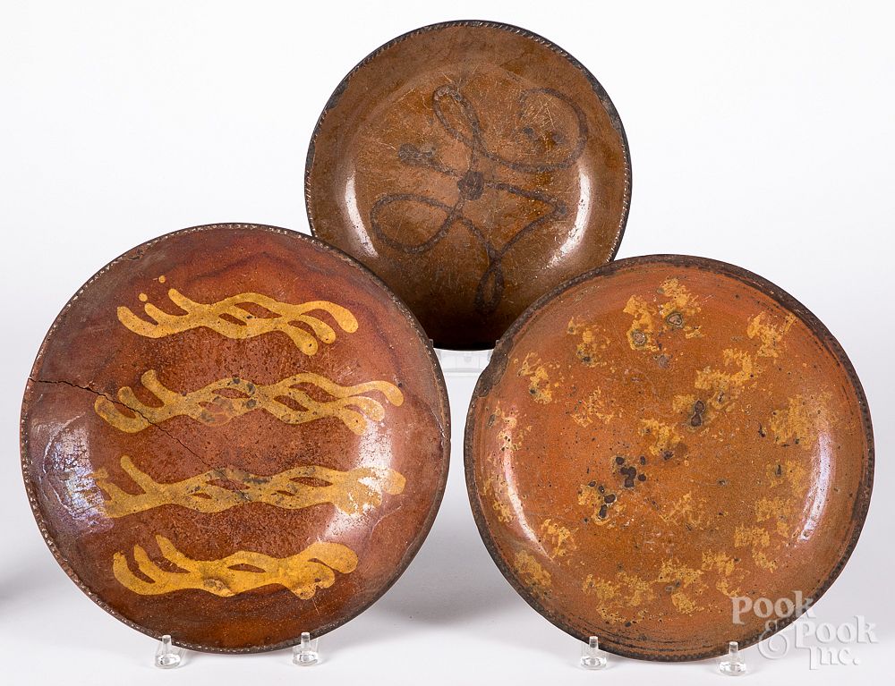 Appraisal: Three redware chargers th c Three redware chargers th c