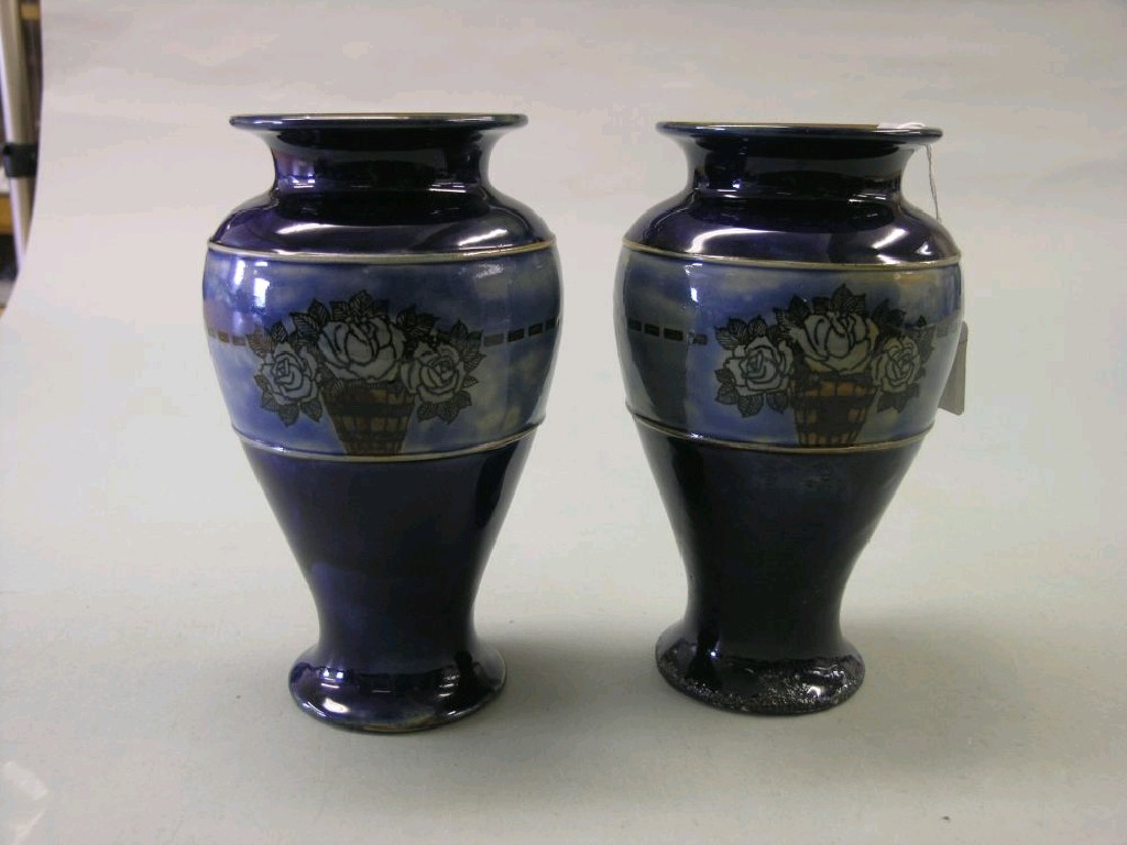 Appraisal: A pair of Royal Doulton glazed stoneware vases baluster shape