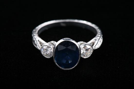 Appraisal: VINTAGE STYLE PLATINUM SAPPHIRE AND DIAMOND RING Bezel-set oval-shaped ct