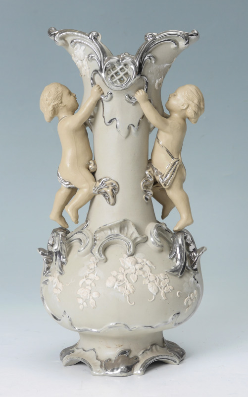 Appraisal: METTLACH PLATINUM OVERLAY CHERUBIC VASE Pierced vase with putti figures