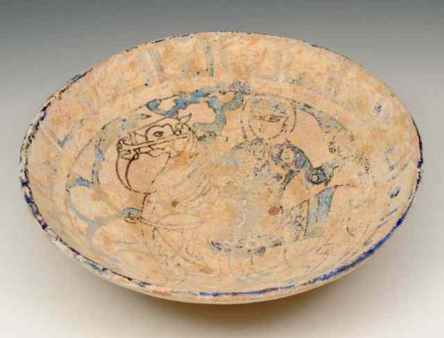 Appraisal: A SIMILAR PERSIAN POTTERY BOWL with single equestrian figure th