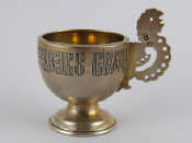 Appraisal: A Russian silver egg cup with handle formed as a