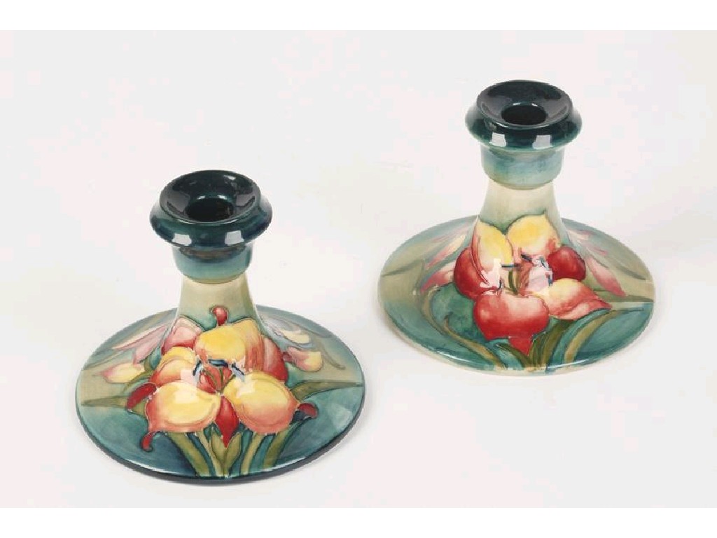 Appraisal: A PAIR OF TABLE CANDLESTICKS with broad spreading circular bases