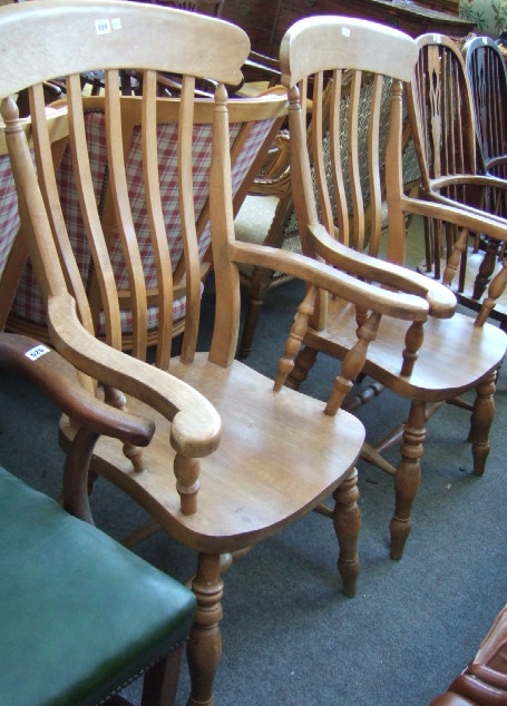 Appraisal: A pair of th century beech kitchen open armchairs with