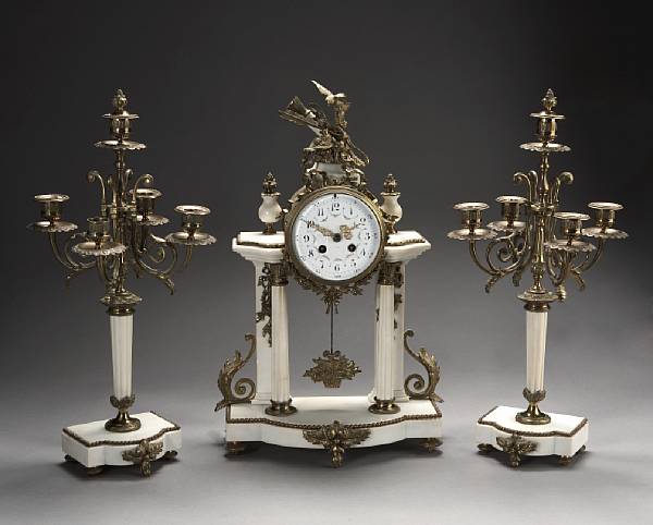 Appraisal: A French gilt bronze mounted white marble three piece clock