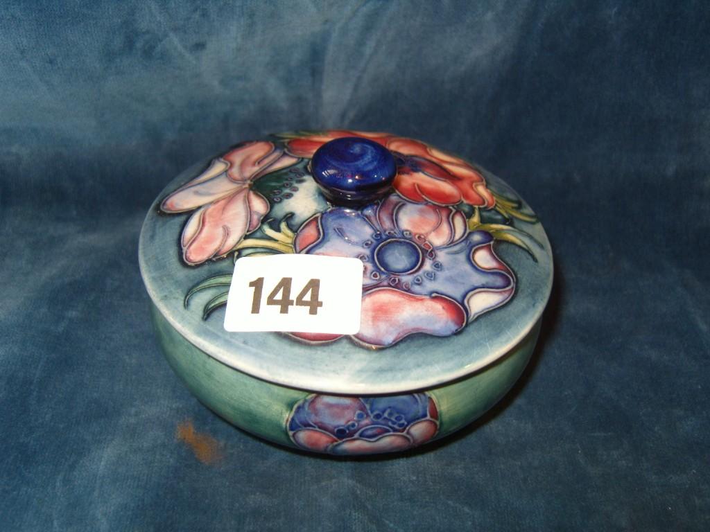 Appraisal: A Moorcroft pale blue ground powder bowl and cover with