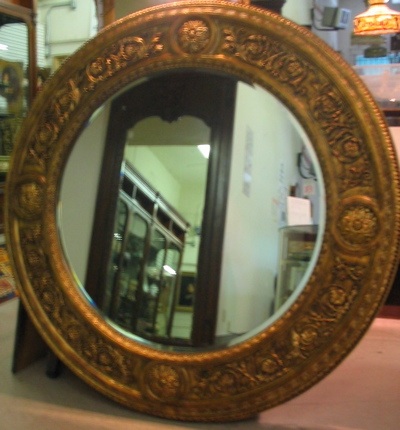 Appraisal: A LARGE ROUND WALL MIRROR which is fully beveled and