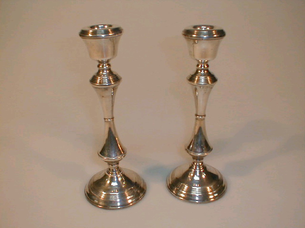 Appraisal: A pair of modern silver candlesticks of knopped reeded tapered