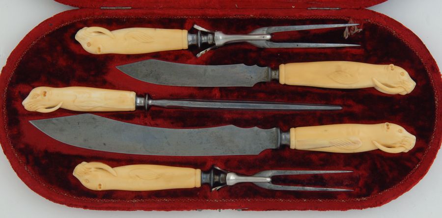 Appraisal: CASED FIVE-PIECE WALRUS TUSK CARVING SET Carved walrus-form handles Blades