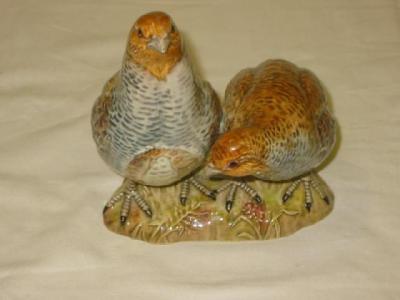 Appraisal: A BESWICK POTTERY GROUP modelled as two partridges No wide