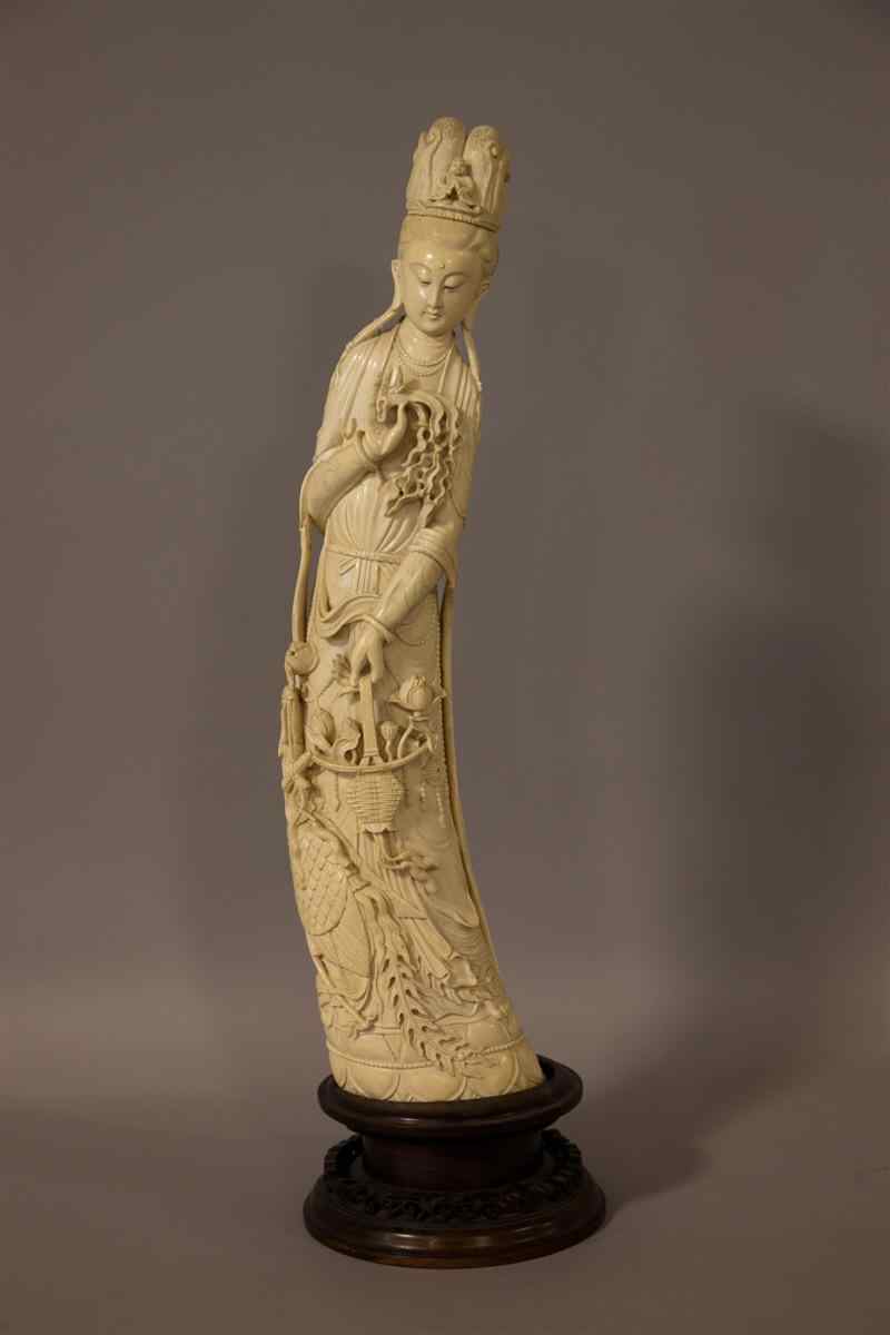 Appraisal: CHINESE IVORY TUSK FIGURE OF GUANYIN AND PHOENIX late th