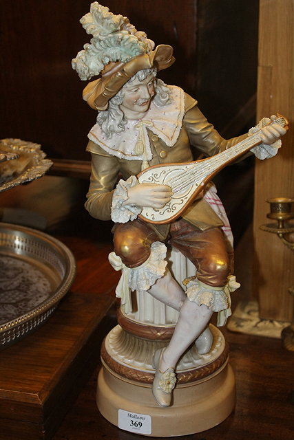 Appraisal: A ROAYL DUX MODEL of a mandolin player seated on