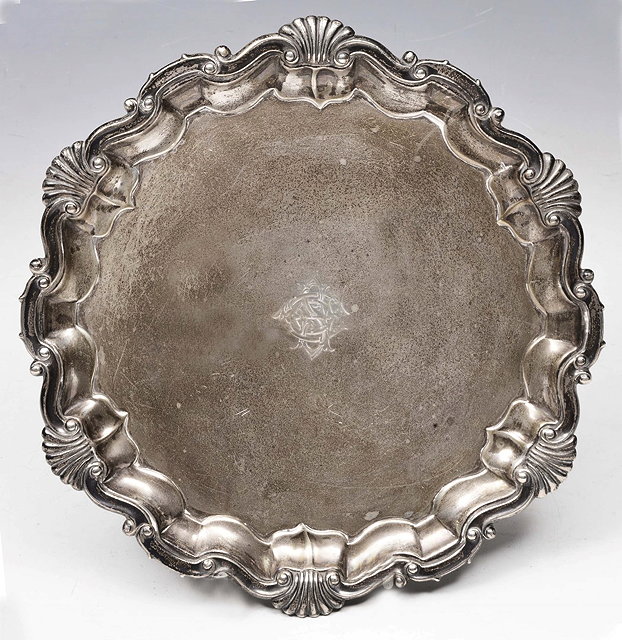 Appraisal: A LATE VICTORIAN SILVER SALVER with scallop scroll cast border