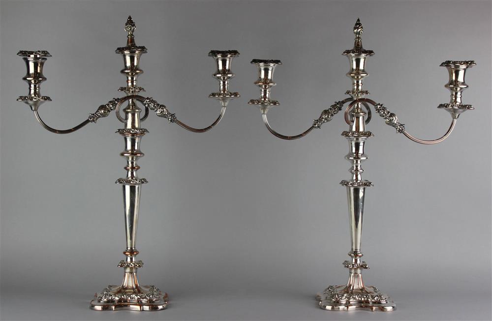 Appraisal: PAIR OF GEORGIAN STYLE SILVERPLATED THREE-LIGHT CANDELABRA each shaped weighted