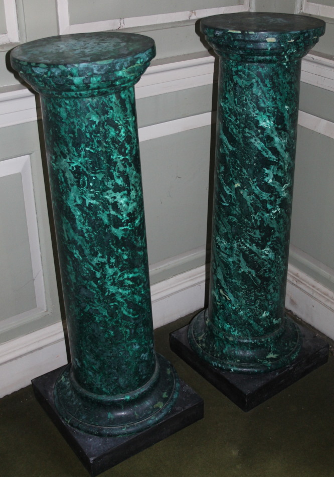 Appraisal: A pair of green simulated marble columns each with a