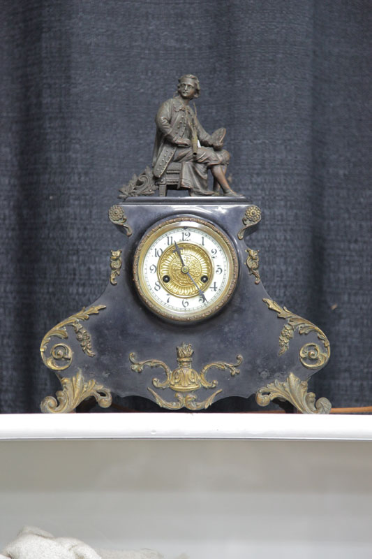 Appraisal: WATERBURY FIGURAL MANTEL CLOCK Eight day time strike with porcelain