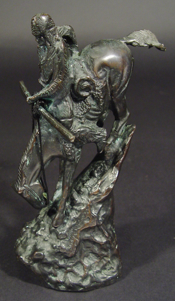 Appraisal: Bronze Red Indian on horseback traversing a steep slope signed