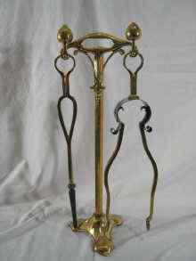 Appraisal: A brass Art Nouveau fireside companion set of tongs and