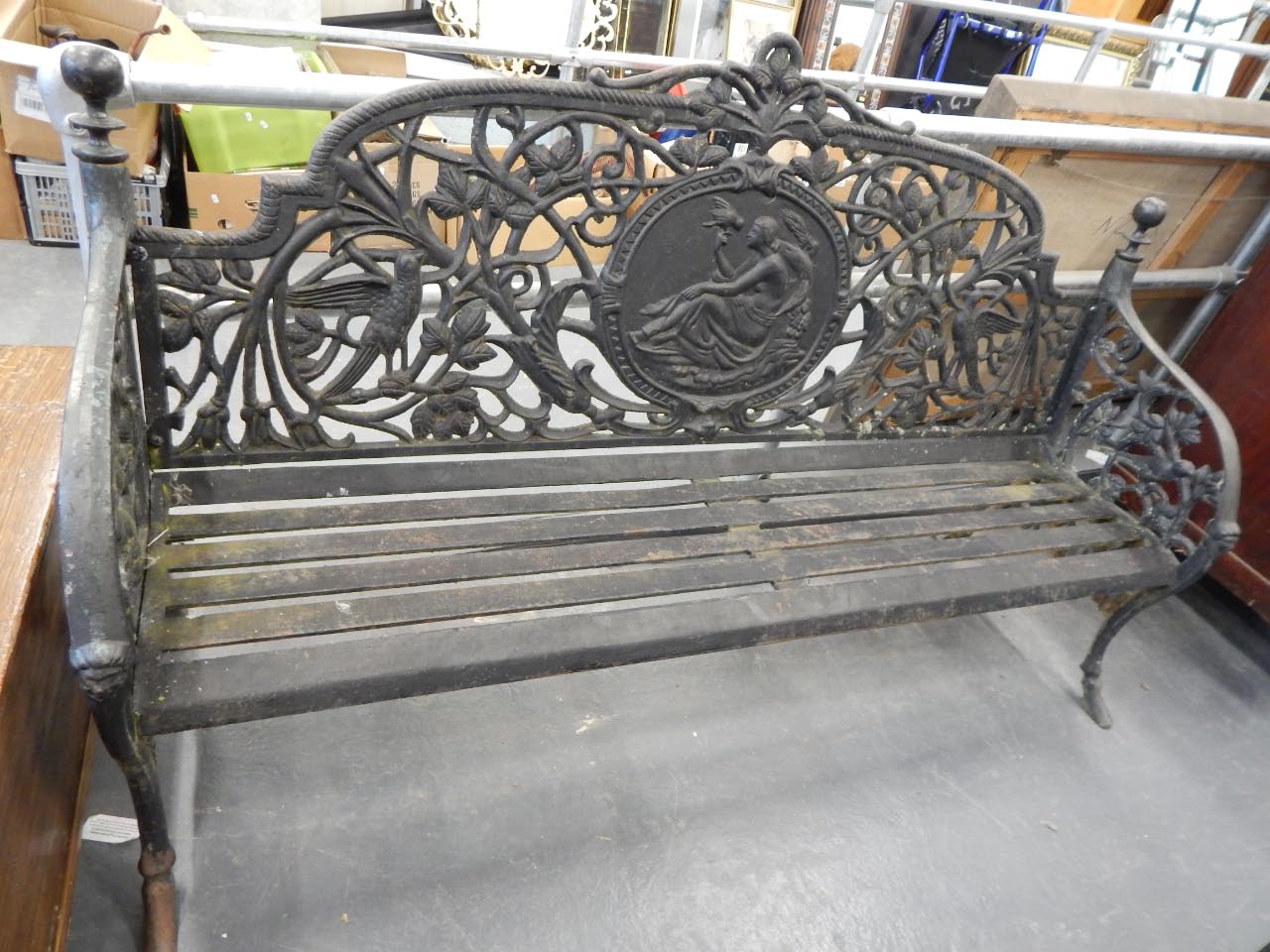 Appraisal: A modern wrought iron garden bench cast with leaves flowers