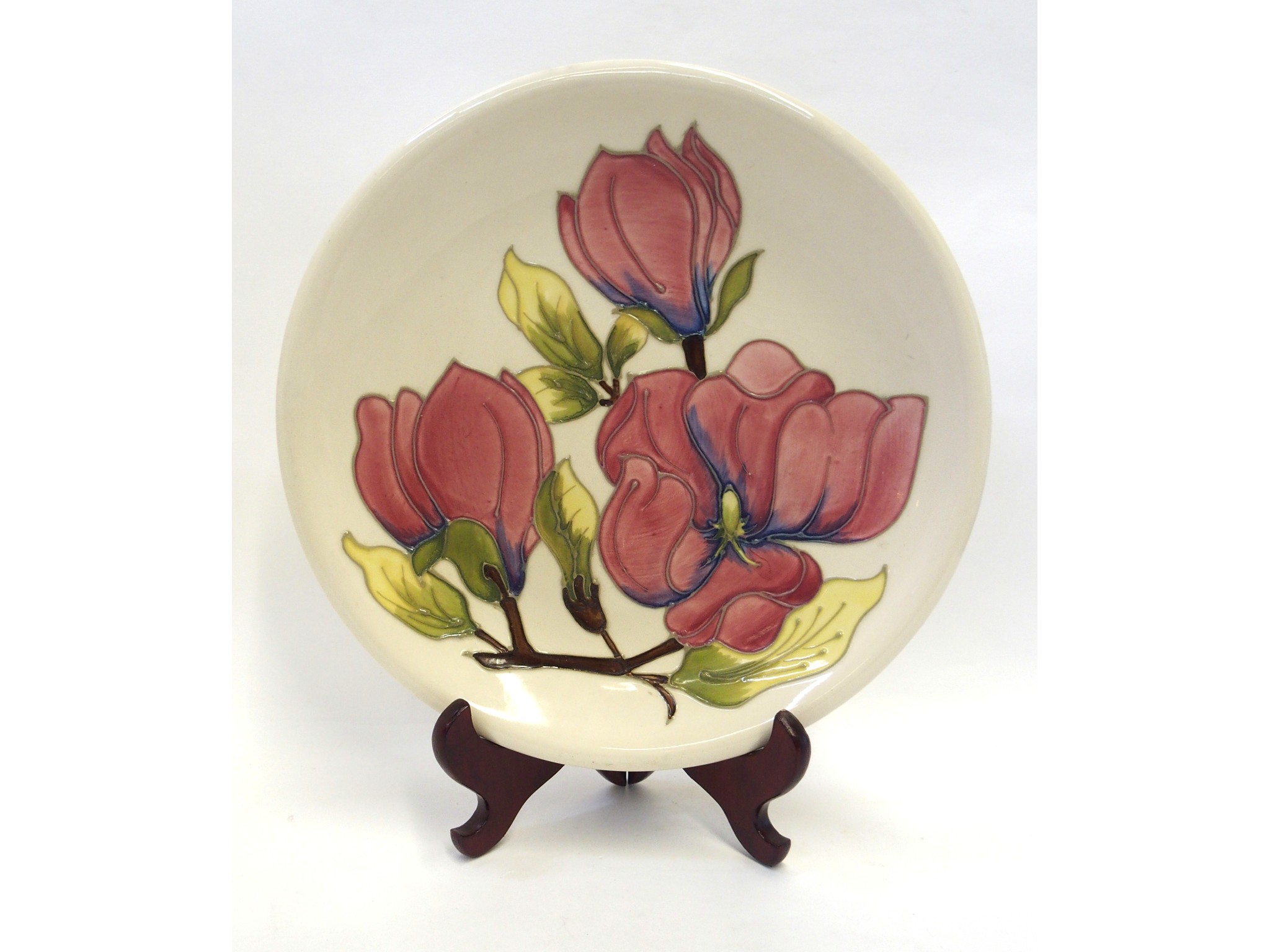 Appraisal: Moorcroft Magnolia plate on cream ground