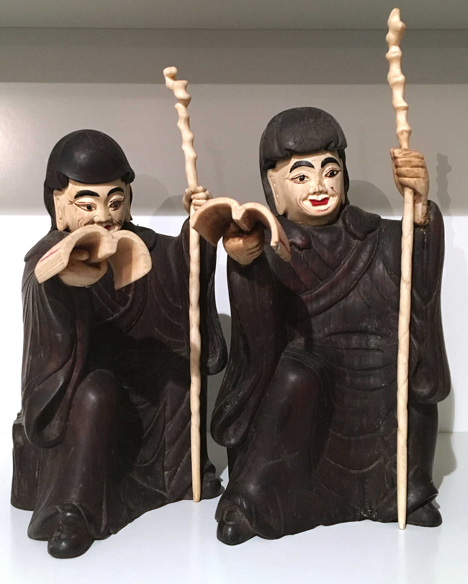 Appraisal: A PAIR OF JAPANESE HARDWOOD AND BONE FIGURES OF SCHOLARS