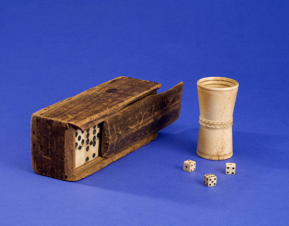 Appraisal: SAILOR'S CARVED WOODEN GAMEBOX WITH TWENTY-SEVEN BONE AND EBONY DOMINOS