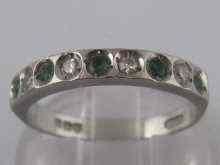 Appraisal: A white metal tests platinum diamond and emerald half eternity