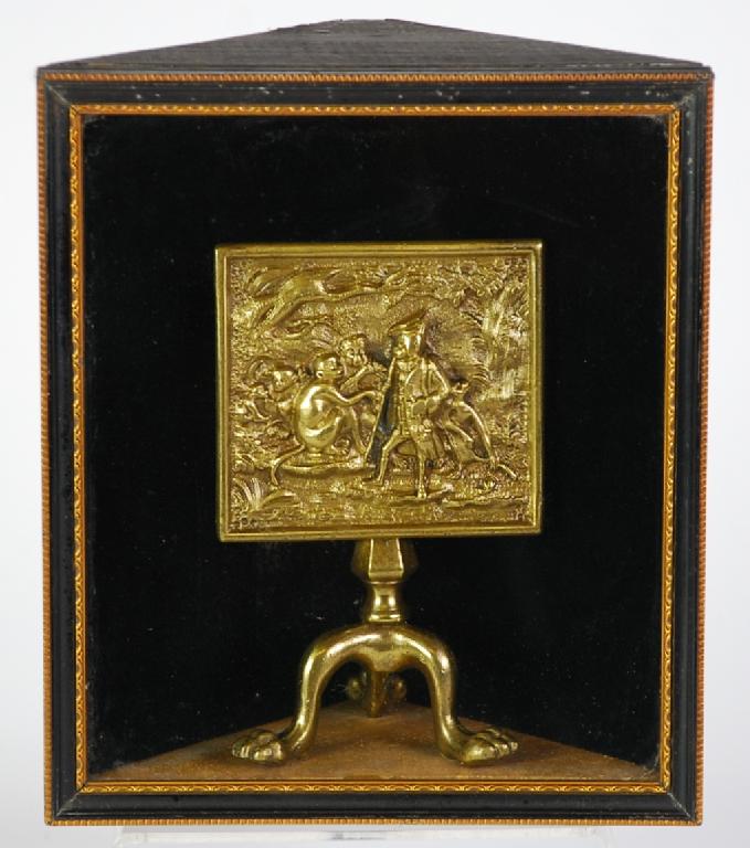 Appraisal: A CURIOUS CAST BRASS MINIATURE TRIPOD TABLE in glazed corner