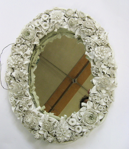 Appraisal: ENGLISH FULHAM POTTERY FRAMED OVAL WALL MIRROR The wide frame