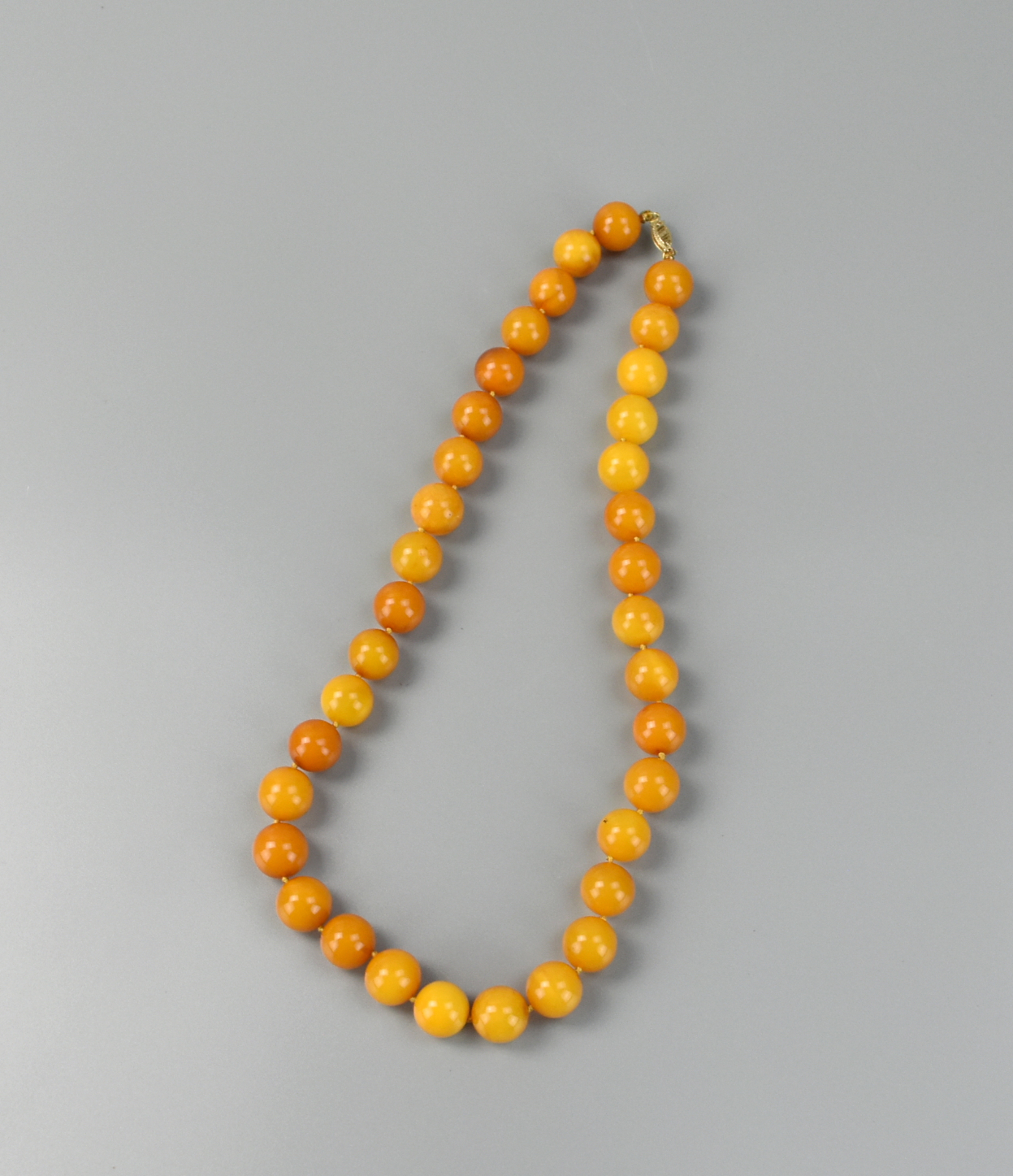 Appraisal: CHINESE BEADED BEESWAX NECKLACE A beaded beeswax necklace with spherical