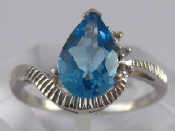 Appraisal: A white metal tests carat gold blue topaz and diamond